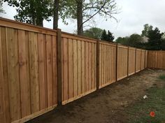 a wooden fence in the middle of a yard