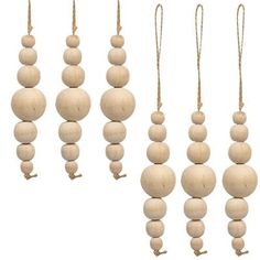 several wooden beads hanging from strings on a white background