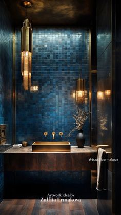 a blue tiled bathroom with gold fixtures and wood flooring is featured in this image