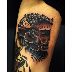 a black and grey tattoo on the leg of a man with an owl head in it