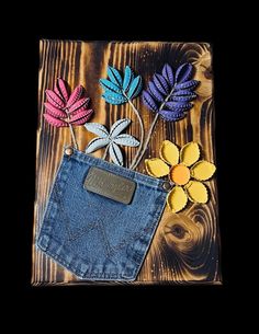 a denim pocket with flowers in it on a wooden surface