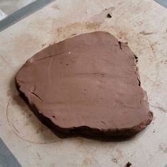 a piece of chocolate cake sitting on top of a counter