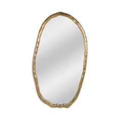 an oval mirror with gold leaf decoration