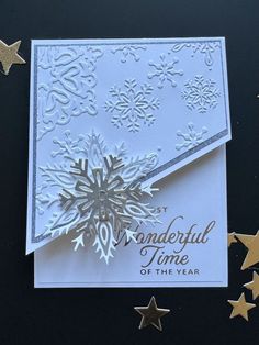 a white card with gold stars and snowflakes on the side, it says wonderful time of the year