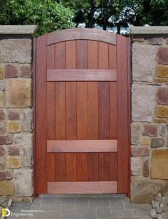 an open wooden door in front of a stone wall