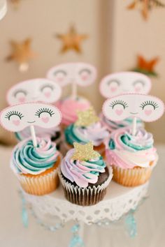 some cupcakes are sitting on a cake plate