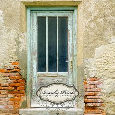 an old door with a sign on it in front of a brick wall and window