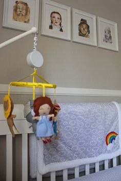 a baby crib with a stuffed animal hanging from it's side