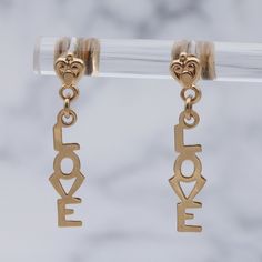 These lightweight Retro 14k gold earrings feature an adorable, tiny, swirled heart at the post with drop lettering of the word "Love." They weigh 0.8 grams and have a drop length of 22mm. They are in great vintage condition with light wear and are marked on the backings as shown. Love Letter Earring, Love Letter, Love Letters, Favorite Jewelry, Jewelry Earrings Dangle, Swirl, Gold Earrings, Etsy Earrings, Dangle Drop Earrings