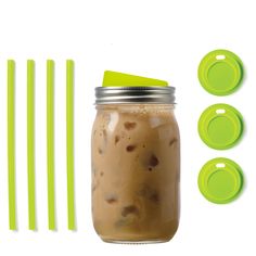 a mason jar filled with liquid next to green straws