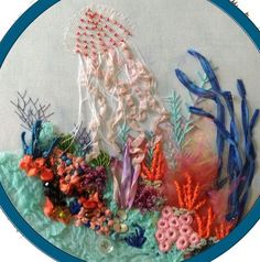 an embroidery project with various sea creatures and corals in the water on a white background