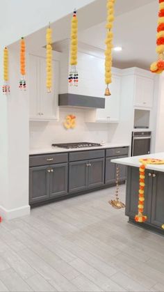 a kitchen decorated with orange and yellow garlands