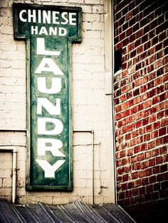 a sign on the side of a building that says laudry chinese hand soaps