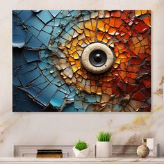 an art piece with a hole in the center on a wall above a fireplace mantel