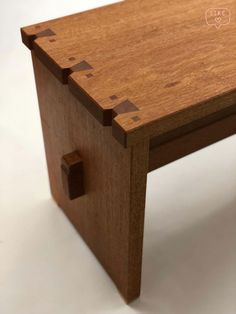 a small wooden table with holes in it