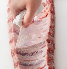 A hand pulling the membrane off of the back of baby back ribs. Babyback Ribs In Oven, Back Ribs In Oven, Oven Baked Pork Ribs, Pork Loin Back Ribs, Oven Pork Ribs, Ribs Recipe Oven, Baked Pork Ribs, Pork Back Ribs, Baby Back Pork Ribs