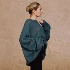 The versatile, luxurious, and elegant silhouette of the sweater ASTRID can be a part of many different looks, at the same time keeping you warm and cosy.  Hand-crafted from premium alpaca and mohair blend, this fluffy pullover features an oversized fit, raglan shoulder construction and extra-long sleeves. Style with jeans for a more casual look, or elegant trousers/skirt for an evening. DETAILS -Oversized -Boat neck -Extra-long puffed sleeve -Raglan shoulder construction Designed and ethically m Luxury Hand-knitted Long Sleeve Sweater, Luxury Oversized Knit Top, Luxury Fitted Alpaca Sweater, Luxury Long Sleeve Mohair Tops, Luxury Green Relaxed Fit Shirt, Luxury Green Knit Sweater, Luxury Oversized Chunky Knit Tops, Luxury Oversized Alpaca Sweater, Luxury Versatile White Blouse