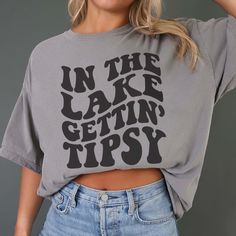 a woman wearing a crop top with the words in the cake getting tipsy on it