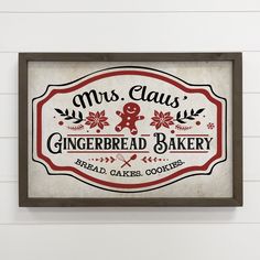 a sign for mrs claus'gingerbread bakery hangs on the wall