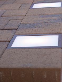 three square windows on the side of a building with no people in them or one person standing outside