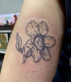 a black and white flower tattoo on the arm