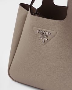 Leather Leather handles Metal lettering logo on the front Metal hardware Magnetic button closure Nappa leather interior with three compartments Dream Purse, Prada Leather Tote, Prada Purse, Purse Collection, Prada Purses, Bags Prada, Metal Lettering, Prada Tote Bag, Soft Leather Tote