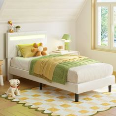 a bedroom with a bed, nightstands and two teddy bears on the floor next to it