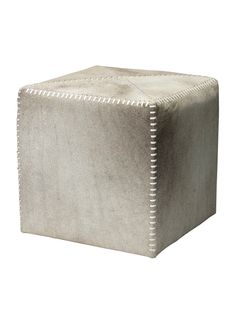 a small square stool with studding on the top and bottom, in grey velvet