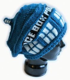 a knitted hat on top of a mannequin's head with words written across it