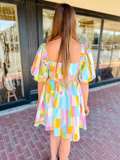 Get ready to turn heads in our Pastel Windowpane Puff Sleeve Dress! With its playful multi color and baby doll style, you'll be the center of attention at any event. The pastel windowpane adds a touch of whimsy to this must-have piece. Don't miss out on this unique dress! Key Features: Bright multi color Puff Sleeves Mini Length Sipper Lined in 90% polyester, 10% spandex Self: 100 Cotton Hand Wash Stylist Review: Model is 5'9" with a 34" bust and a 29" waist and usually wears a medium or large i Spring Multicolor Puff Sleeve Mini Dress, Multicolor Puff Sleeve Mini Dress For Spring, Fun Rainbow Dress For Playtime, Fun Rainbow Playtime Dress, Fun Multicolor Dresses For Garden Party, Fun Multicolor Dress For Garden Party, Retro Spring Playtime Dresses, Spring Puff Sleeve Playtime Dress, Spring Playtime Puff Sleeve Dress