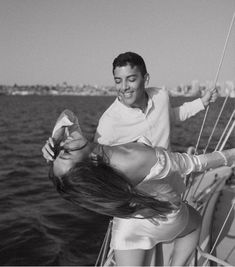 black and white photograph of a woman on a sailboat