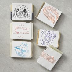 four rubber stamps with drawings on them sitting next to each other in front of a piece of paper