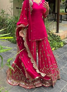 a woman in a pink outfit posing for the camera