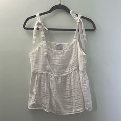 - Nwot - New Without Tags - White Tank Top With Tie Straps - Baby Doll Cut - Super Cute - Lightweight. - Size: Medium (M) - Adjustable Tie Straps - Elastic-Like Back White Tank Top With Tie Straps For Day Out, White Tops With Tie Straps For Daywear, White Tie Strap Tops For Daywear, White Tie Straps Tops For Daywear, White Cotton Tank Top With Tie Straps, Cute White Sleeveless Blouse, White Cotton Tank Top For Daytime, White Vacation Tops With Tie Straps, White Tops With Tie Straps For Vacation