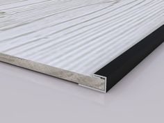 an image of a white and black wall with metal trims on the bottom half