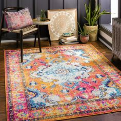 a brightly colored area rug in the corner of a room