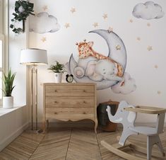 a child's room with a baby elephant and giraffe sleeping on the moon