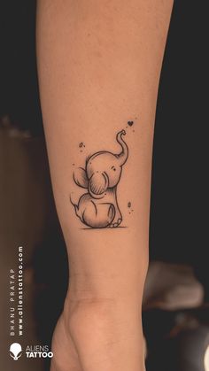 an elephant tattoo on the leg of a woman