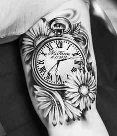 black and white photo of a clock with sunflowers on the side of his arm