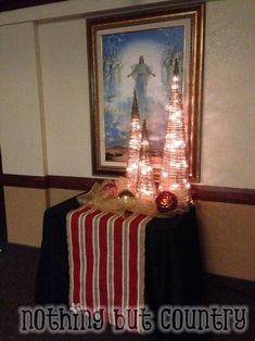 a christmas tree is lit up in the corner of a room with lights on it