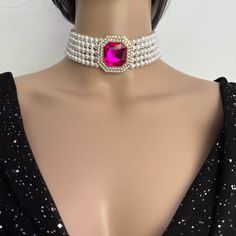 Make a statement with this Layered Pearl Choker Necklace with 5 layers of pearls and stunning pink diamanté brooch. Materials: 6mm Luxurious Shell Pearls, Rhinestones brooch, Gold plated brass clasp. Shell pearls are made from crushed shells. Oyster shells are cut and transformed into powder and then reformed into perfect pearl shape with an infinite shine. They are very popular as a natural alternative to expensive pearls.  Each glossy bead is crafted to mimic the radiant beauty of real pearls, Pink Choker Jewelry For Formal Occasions, Pink Pearl Jewelry For Party, Party Pearl Necklace With Crystal Pendant, Formal Pink Choker Jewelry, Evening Pearl Choker Necklace, Pink Formal Choker Jewelry, Elegant Pink Bridal Necklace With Jewels, Pink Pearl Pendant Jewelry For Party, Evening Pearl Chain Choker