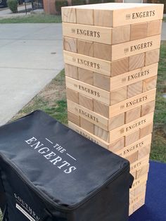 several wooden blocks stacked on top of each other in front of a blue carpeted area