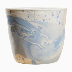 a blue and white ceramic bowl with an animal design on it's side, against a white background