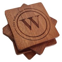 three wooden coasters with the letter w engraved on them, sitting side by side