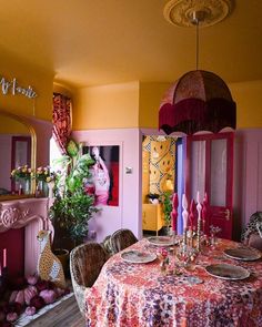 the dining room is decorated in pink and yellow