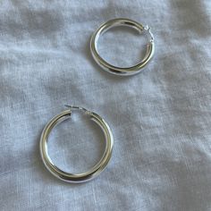 These bright .925 Sterling Silver hoop earrings will be a perfect touch of your style. SHIPS NEXT DAY All hoops are sold in pairs. * .925 Sterling Silver Hoops. They are hypoallergenic, safe for sensitive ears. - XLarge Hoop Earrings 40 mm (4cm) (1.57 inch) If you want to buy gold, https://www.etsy.com/listing/840477349 * All of our jewelry arrives carefully packaged in a free jewelry bag. It's ready for gifting. * If you want a personalized message sent with the order to your recipient, the opt Single Silver Hoop Earring, Minimalist Hoop Earrings With Shiny Finish, Everyday Trendy Sterling Silver Hoop Earrings, Everyday White Gold Hoop Earrings, Sterling Silver Hoop Earrings For Everyday, Silver Small Hoop Earrings For Everyday, Trendy Silver Hoop Earrings For Anniversary, Silver Hoop Earrings With Sterling Silver Clasp, Silver Round Hoop Earrings For Everyday