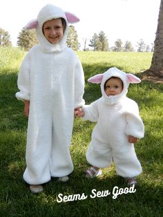 two children dressed up in bunny costumes standing on the grass with their hands in each other's pockets