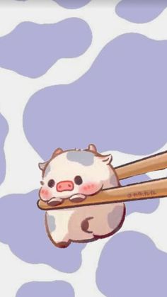 an animal holding two chopsticks in it's mouth