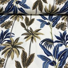 a blue and gold palm tree print fabric