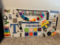 a bulletin board with lots of crafting supplies on it's sides and the letter t